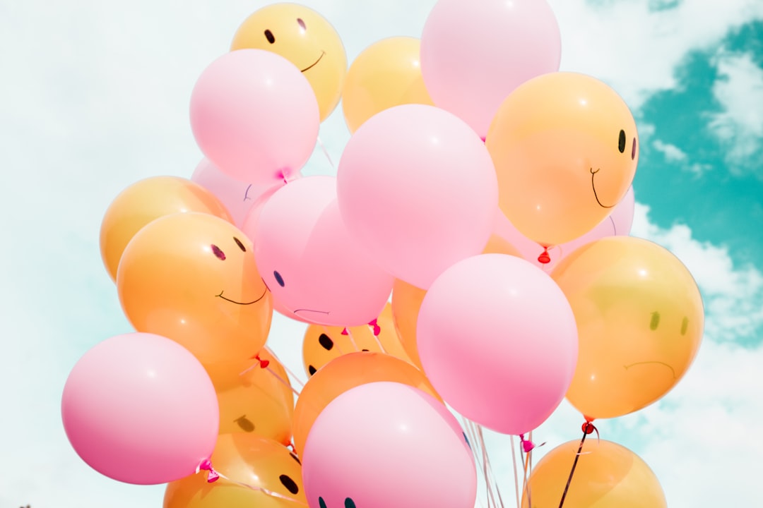 low-angle photo of pink and orange balloons low-angle photo of pink and orange balloons
